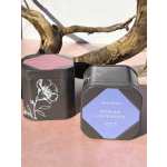 Two square gray candle tins labeled Apricot Rose and Roman Lavender with a wood branch behind them