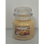 Glass jar candle labeled Spiced Vanilla Apple
