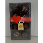 Box of chocolate truffles with a red heart ribbon