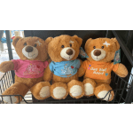 Three teddy bears wearing "Get Well Soon" shirts sit in a display basket.