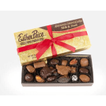 Gold box of assorted milk and dark chocolates with red ribbon and open tray of candies