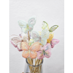 Pastel embroidered butterfly stems in a glass vase