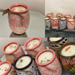 Decorative candles in painted ceramic holders tied with twine