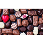 Assorted chocolates arranged in rows on a dark surface