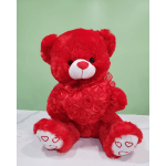 Red teddy bear holding a heart-shaped decoration