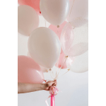 Cluster of pink and white balloons tied with ribbons