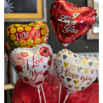 Heart-shaped love-themed balloons in red, white, and gold