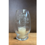 Glass candle holder with memorial text and a small white candle inside