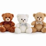 Three teddy bears with polka dot bows on a white background
