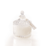 Clear glass candle jar with a white candle and decorative lid