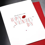 Valentine's Day greeting card with red and gray text and a lips graphic