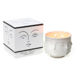 White face-shaped candle beside its matching box