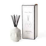 White skull-shaped reed diffuser with black reeds and a box
