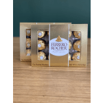 Two boxes of Ferrero Rocher chocolates on a wooden surface