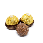 Three chocolate truffles, two wrapped in gold foil