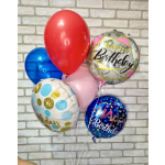 Cluster of birthday balloons in red, blue, pink, and printed designs