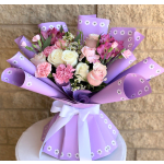 Bouquet of pink and white roses, carnations, and alstroemeria in purple wrap
