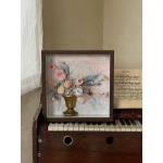 Framed floral arrangement with pastel roses in a gold vase
