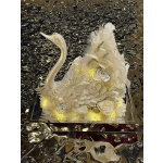 White floral swan sculpture with feathers and roses on a mirrored base