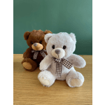 Two plush teddy bears with checkered bows sit on a wooden surface.