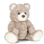 Plush teddy bear with beige fur and white paws on a white background