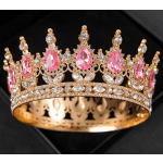 Jeweled gold crown with pink and clear stones on a black background