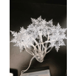 Clear snowflake string lights on a dark surface