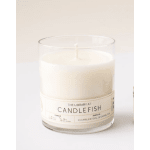 White candle in a clear glass jar with a labeled front