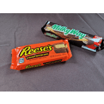 Two candy bars on a gray fabric surface