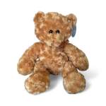Light brown plush teddy bear with curly fur and a small ribbon bow, sitting upright.