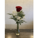 Single red rose in a clear glass vase with white baby's breath
