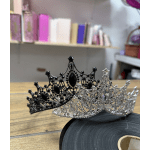 Two jeweled tiaras resting on a table
