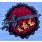 Bouquet of red roses wrapped in black paper with a black ribbon and butterfly accents