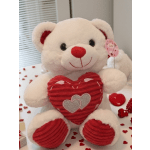 White teddy bear holding a red heart with small heart decorations