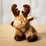 Plush reindeer toy with brown antlers and hooves