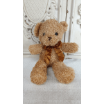 Teddy bear plush with a brown ribbon bow