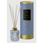 Reed diffuser in a faceted glass bottle with a blue and gold tube