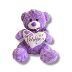 Purple teddy bear holding a heart-shaped pillow with the word Love