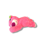 Pink teddy bear plush lying on its side with a strawberry accent
