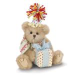 Teddy bear with a party hat holding a wrapped gift