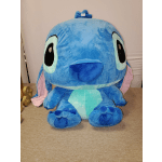 Large blue plush character with big eyes and floppy ears