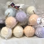 Pastel-colored round bath bombs wrapped in clear plastic