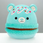 Turquoise plush bear with a smiling face and heart decorations