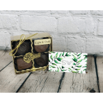 Box of assorted chocolates beside a leafy business card
