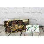 Box of milk chocolate candies with a small floral card