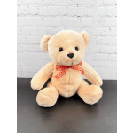 Plush teddy bear with a red ribbon bow