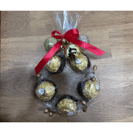 Chocolate candies wrapped in clear plastic with a red bow