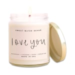 Labeled candle in a glass jar with a gold lid