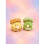 Two cartoon animal macarons on a pastel background