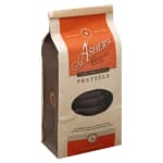 Bag of dark chocolate covered pretzels in a kraft paper package with orange label and window.